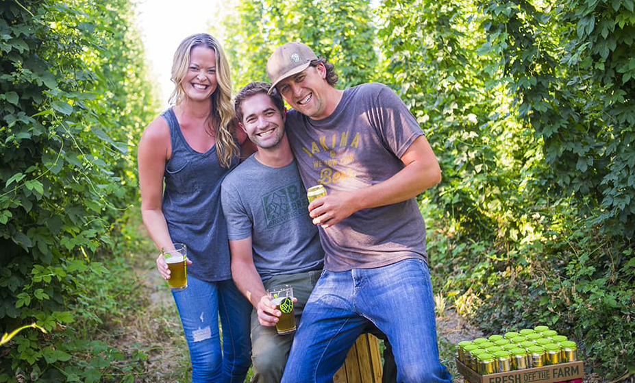 Meghann and Kevin Quinn with Kevin Smith (center) in hops field
